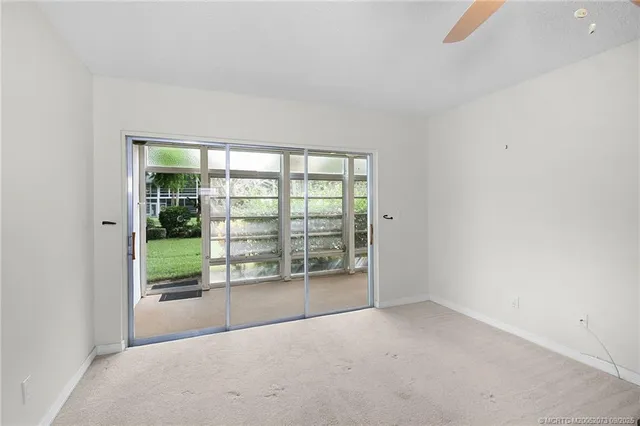an empty room with wooden floor and sliding door