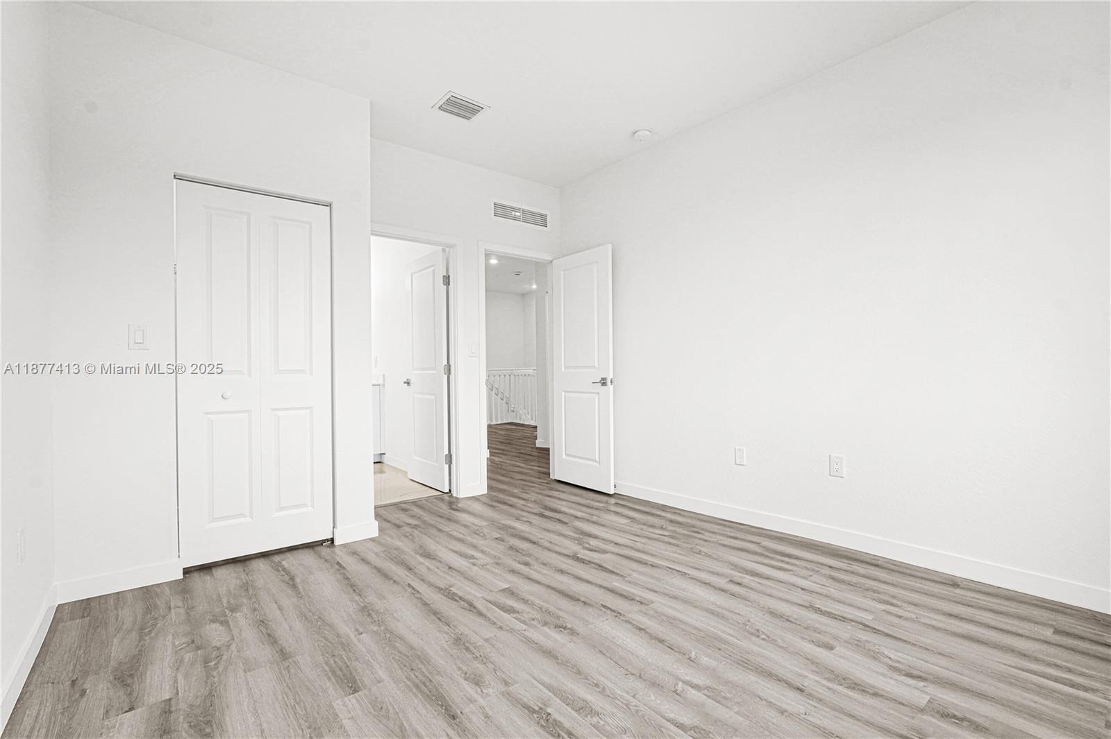 22425 Southwest 125th Avenue, Unit 19A Miami, FL 33170 - Photo 54 of 61 a view of an empty room with wooden floor