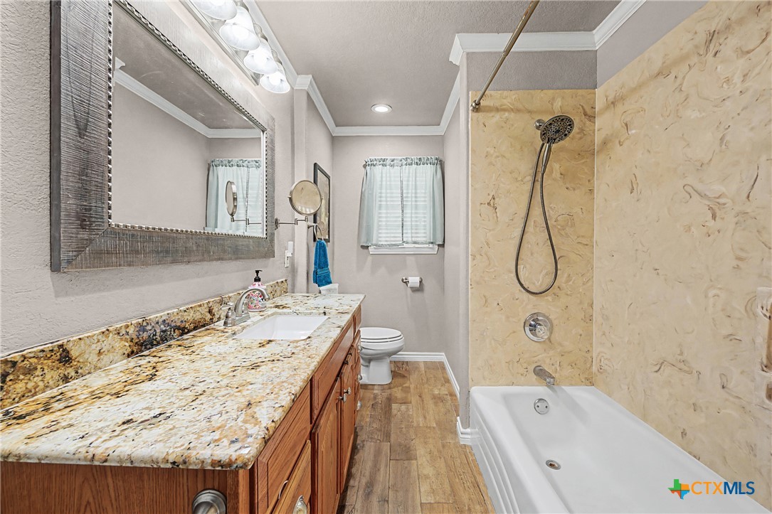 1601 Sunset Circle Cameron, TX 76520 - Photo 25 of 40 a bathroom with a tub sink and mirror