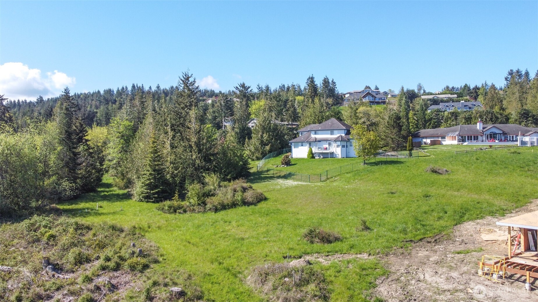 623 Doe Run Road Sequim, WA 98382 - Photo 13 of 13 a view of a garden with a building in the background