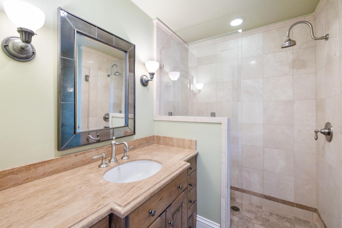 74 Lilac Drive Atherton, CA 94027 - Photo 40 of 81 a bathroom with a granite countertop sink a mirror and shower