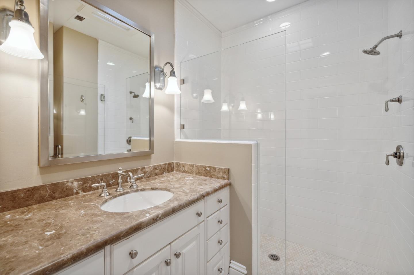 74 Lilac Drive Atherton, CA 94027 - Photo 43 of 81 a bathroom with a granite countertop sink and a mirror