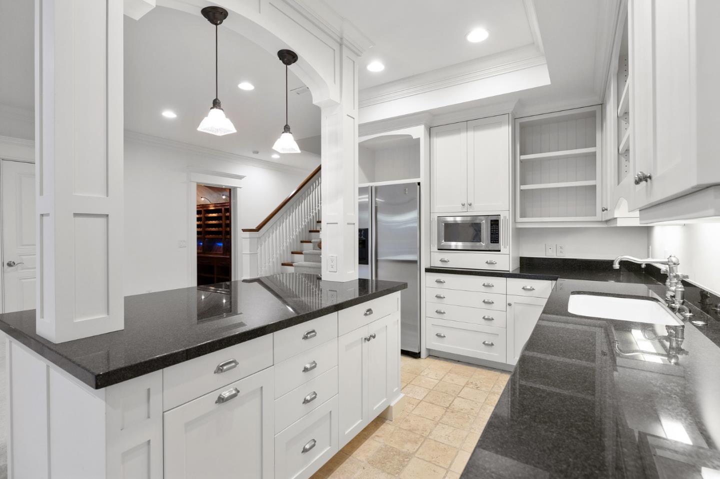 74 Lilac Drive Atherton, CA 94027 - Photo 48 of 81 a kitchen with granite countertop a sink a stove and cabinets