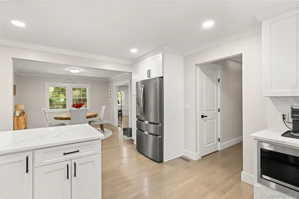 a kitchen with stainless steel appliances a refrigerator and a stove top oven