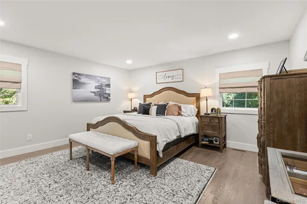 a bedroom with a bed table and a window