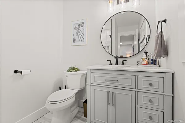 a bathroom with a toilet a sink and a mirror