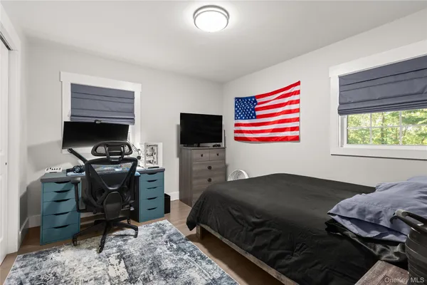 a bedroom with a bed and a television