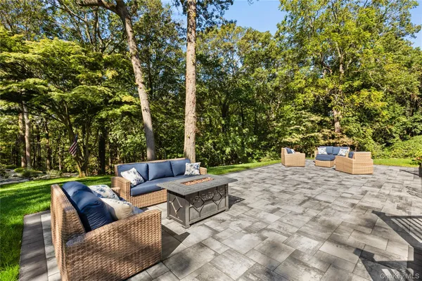 a backyard of a house with table and chairs