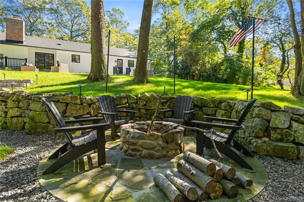 a view of a swimming pool with a patio and a yard