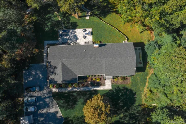 an aerial view of a house with yard swimming pool and outdoor seating
