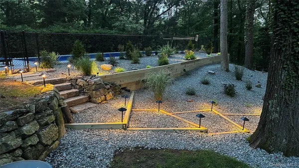 a view of swimming pool with a patio and a yard