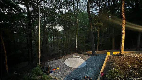 a backyard of a house with table and chairs