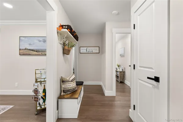 a view of a hallway with wooden floor and entryway