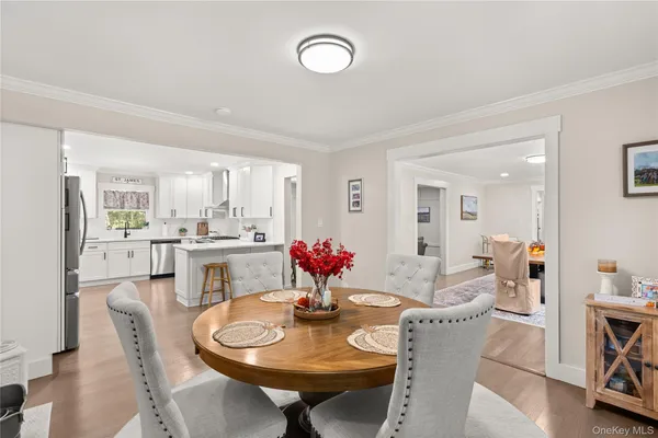 a view of a dining room with furniture and wooden floor