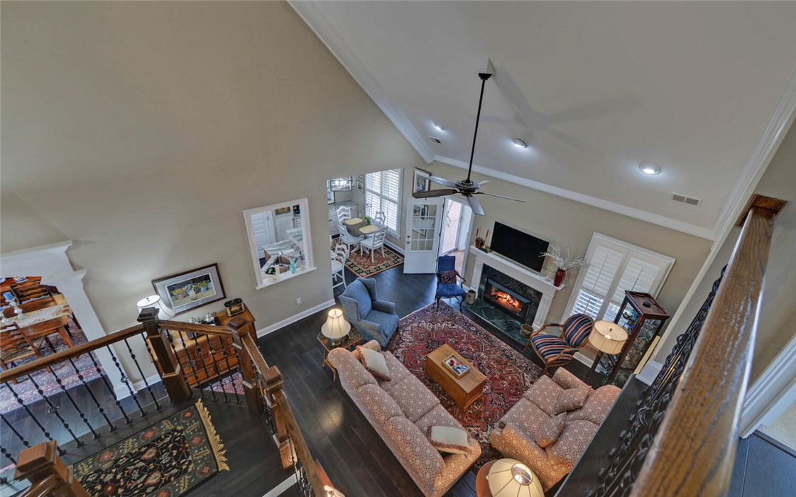 39 Azalea Drive Hartwell, GA 30643 - Photo 11 of 45 An inviting living room features high ceilings, a cozy fireplace, and rich hardwood flooring.