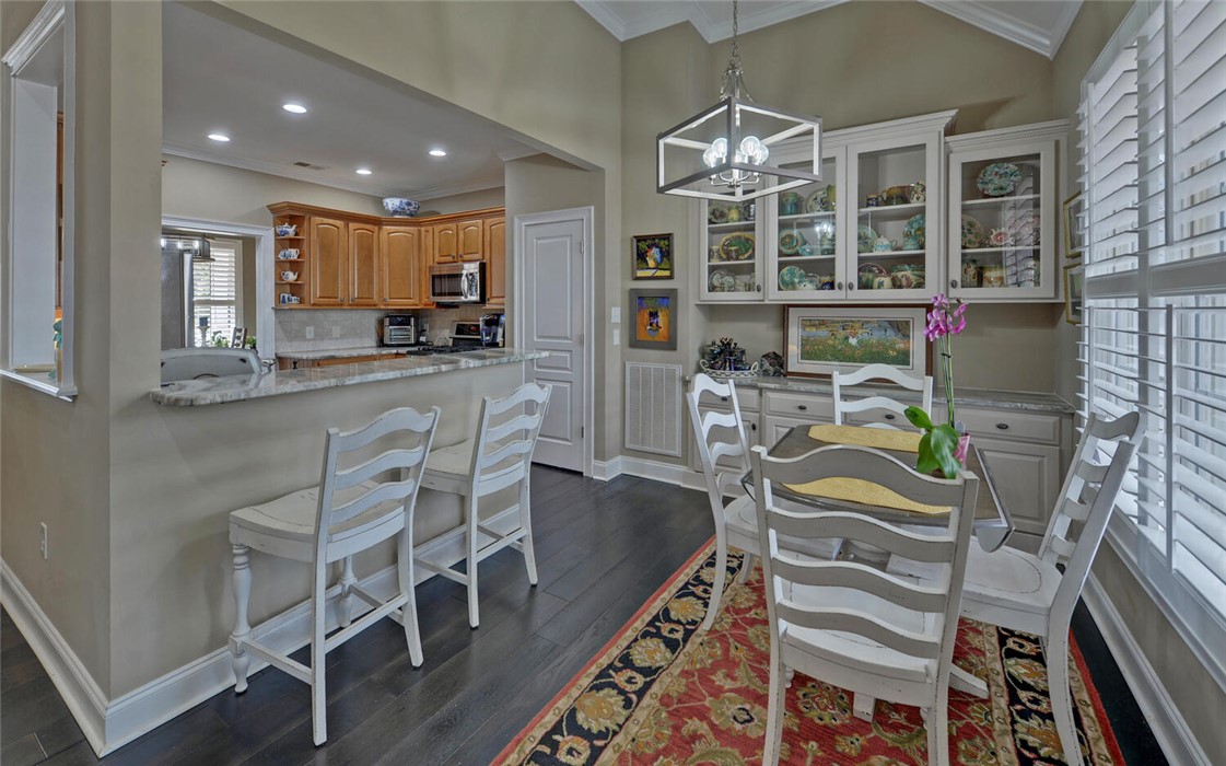 39 Azalea Drive Hartwell, GA 30643 - Photo 13 of 45 This inviting dining area features a pass-through to the kitchen, creating an open and airy atmosphere.