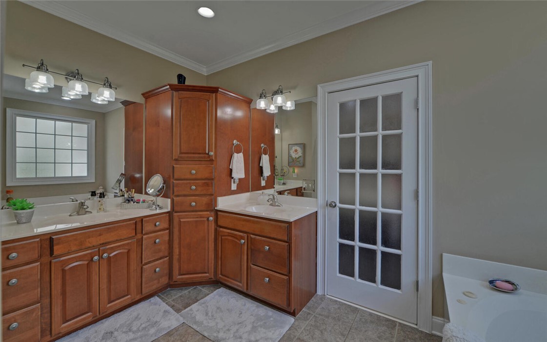 39 Azalea Drive Hartwell, GA 30643 - Photo 22 of 45 This bathroom features dual vanities with ample storage and a glass-paneled door.