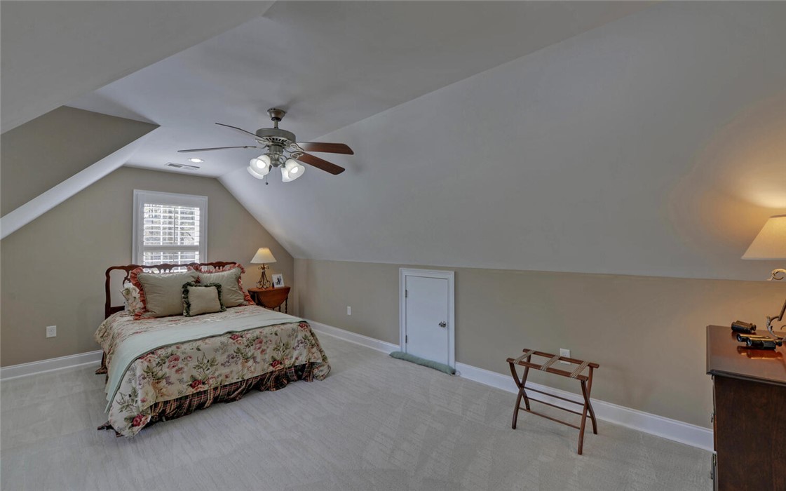 39 Azalea Drive Hartwell, GA 30643 - Photo 38 of 45 This cozy bedroom retreat features soft carpeting and sloped ceilings, creating a unique and inviting space.
