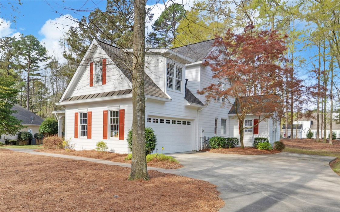 39 Azalea Drive Hartwell, GA 30643 - Photo 45 of 45 This bright white home features classic red shutters and a well-maintained driveway.