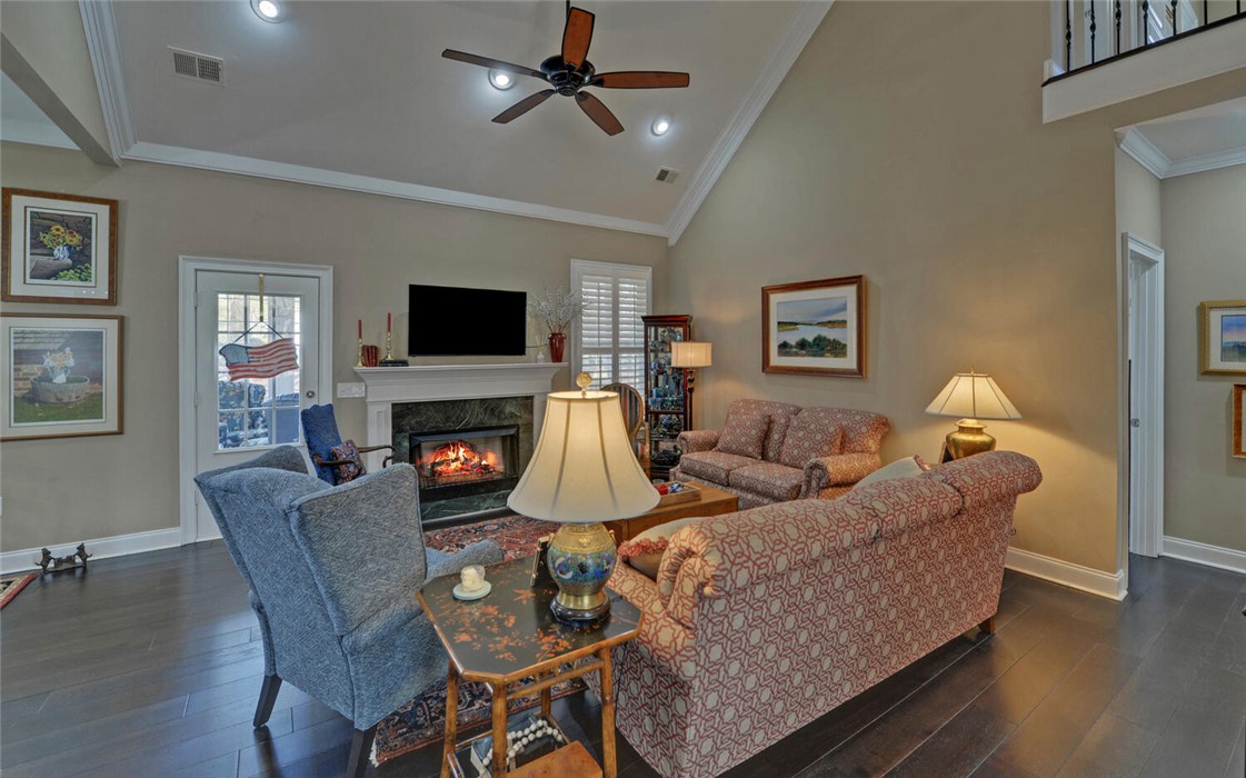 39 Azalea Drive Hartwell, GA 30643 - Photo 9 of 45 This inviting living area boasts rich hardwood floors and a cozy fireplace, perfect for relaxing evenings.