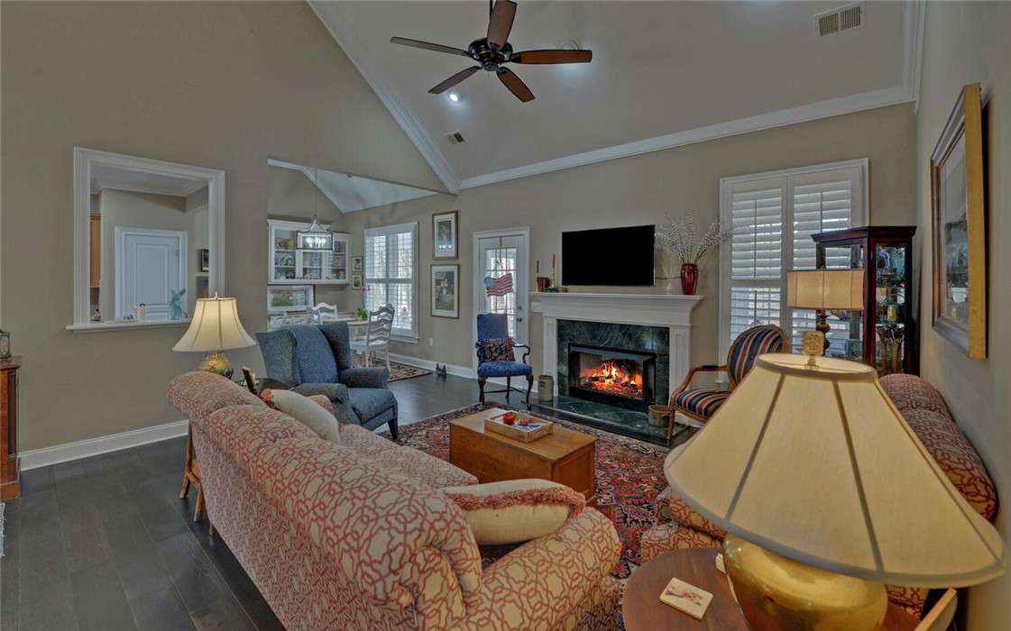 39 Azalea Drive Hartwell, GA 30643 - Photo 10 of 45 This inviting living area boasts high ceilings, a cozy fireplace, and rich hardwood flooring, perfect for comfortable gatherings.