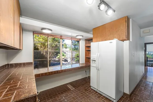 a kitchen with refrigerator and countertop