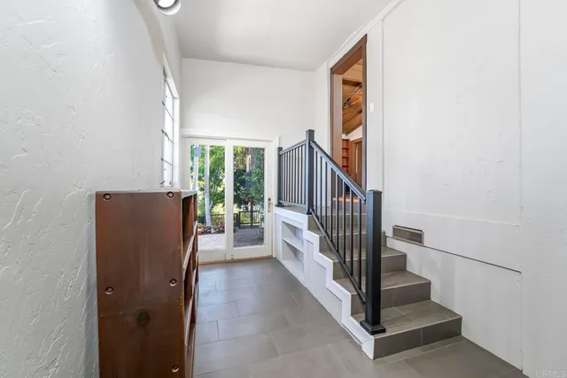 a view of entryway with wooden floor and stairs