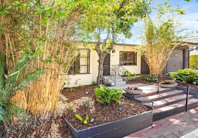 a front view of a house with garden