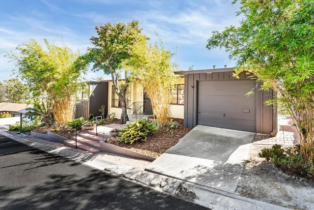a front view of a house with a yard and a garage