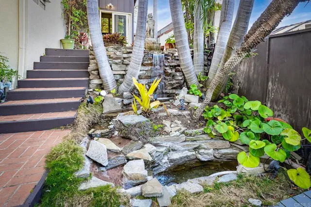 a view of a house with wooden fence