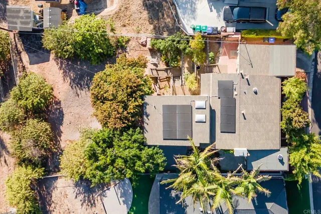 an aerial view of multiple houses with yard