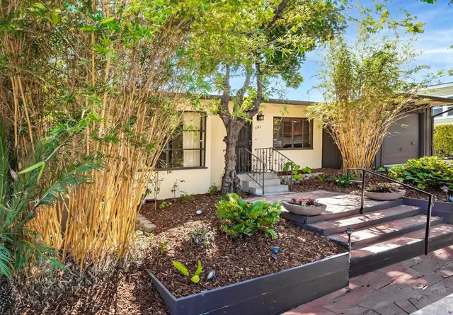 a front view of a house with garden