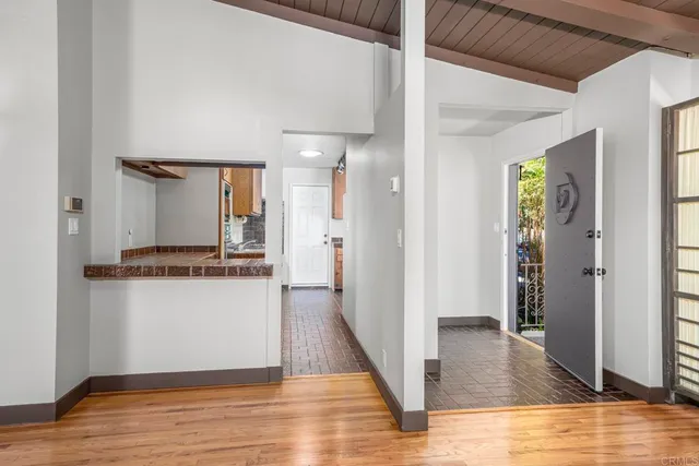 a view of a hallway with wooden floor