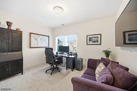 a living room with furniture rug and window