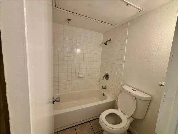 a bathroom with a toilet and a bathtub
