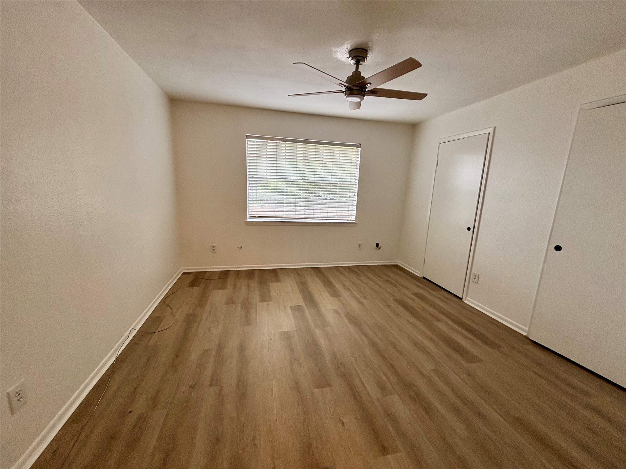 2800 Jeanetta Street, Unit 2008 Houston, TX 77063 - Photo 15 of 22 a view of empty room with wooden floor and fan