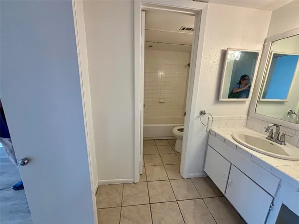 a bathroom with a sink a toilet and mirror