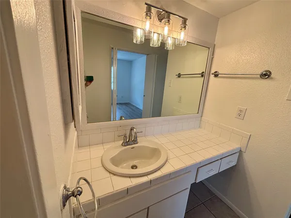 a bathroom with a sink and a mirror