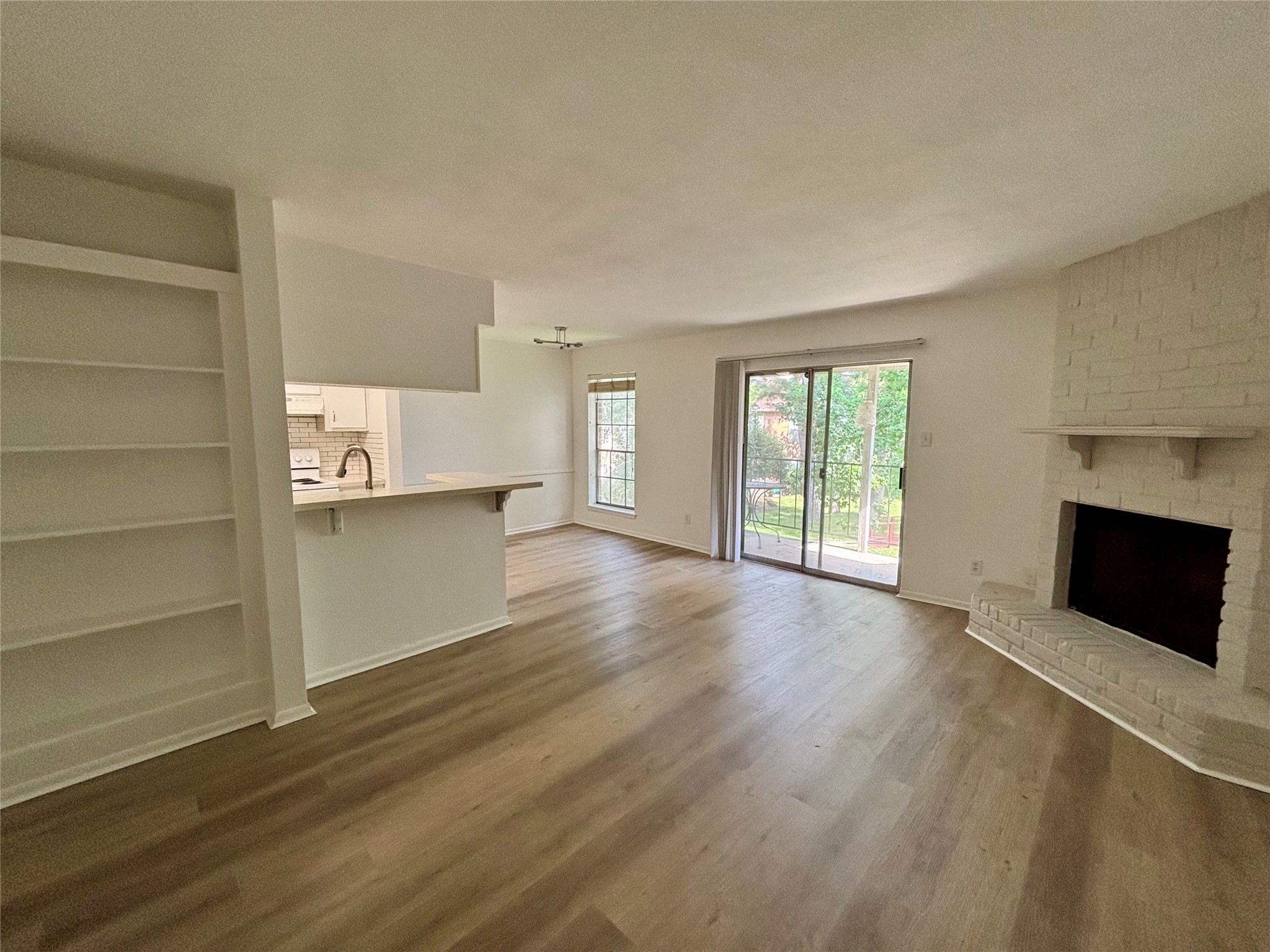 2800 Jeanetta Street, Unit 2008 Houston, TX 77063 - Photo 18 of 22 a view of an empty room with a fireplace and a window