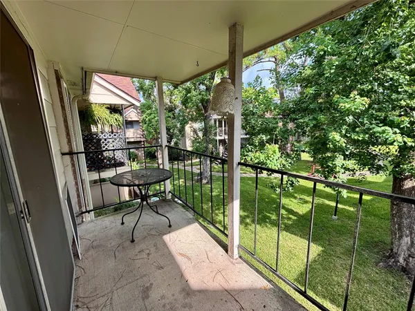 a view of a porch with chairs and backyard