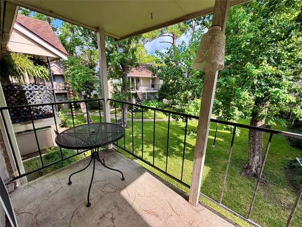 a view of a chairs and table in patio