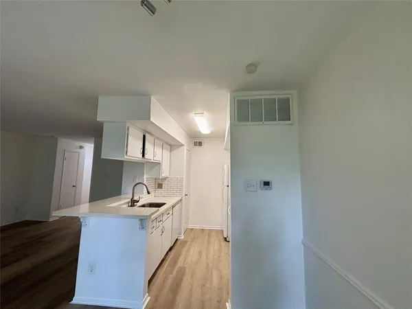 a kitchen with a sink and a refrigerator