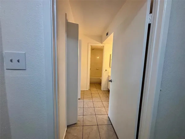 a view of a bathroom from a corridor