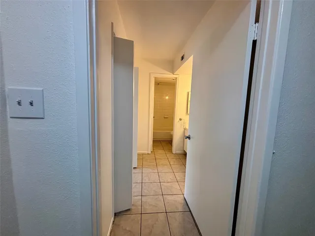 a view of a bathroom from a corridor