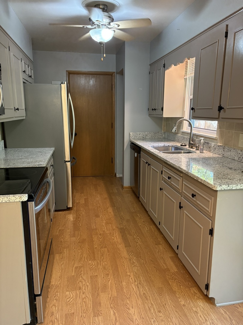 5209 12th Avenue Moline, IL 61265 - Photo 13 of 33 a spacious bathroom with a granite countertop sink a mirror and shower