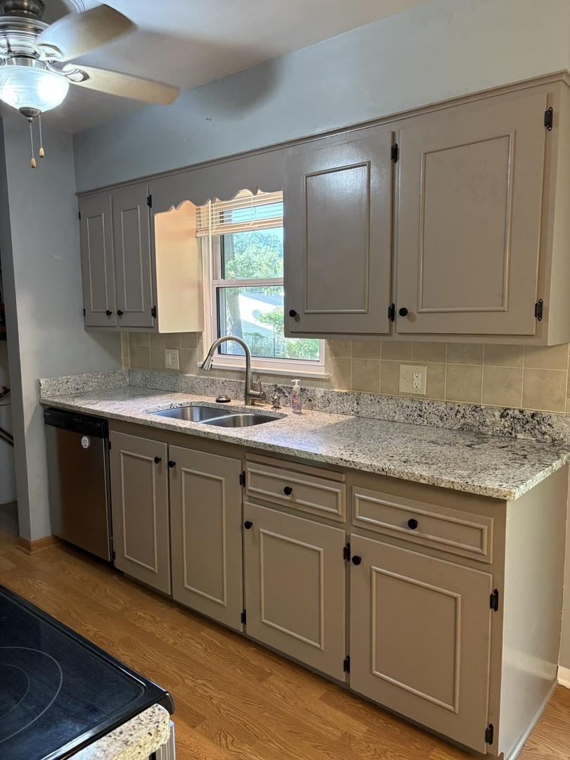 5209 12th Avenue Moline, IL 61265 - Photo 15 of 33 a kitchen with granite countertop a sink and cabinets