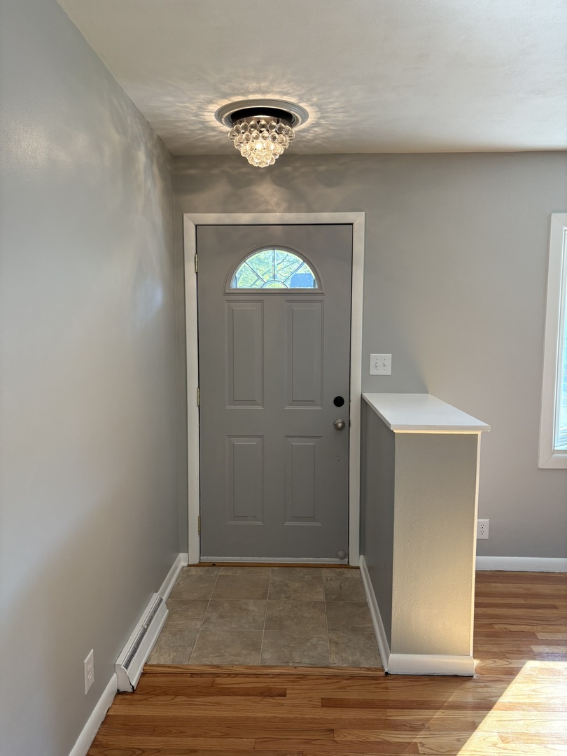 5209 12th Avenue Moline, IL 61265 - Photo 6 of 33 an empty room with wooden floor closet and windows