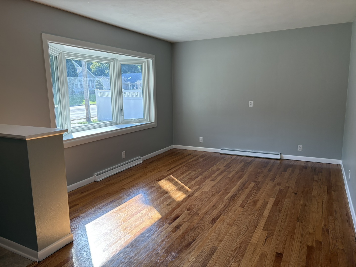 5209 12th Avenue Moline, IL 61265 - Photo 7 of 33 a view of an empty room with wooden floor and a window