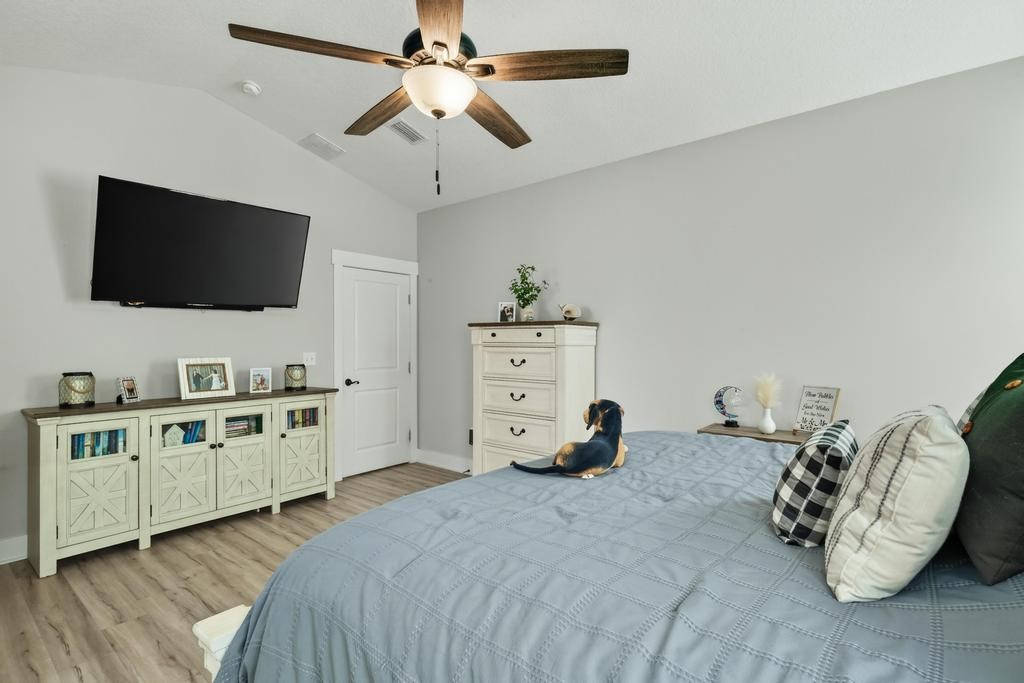 75774 Edwards Road Yulee, FL 32097 - Photo 41 of 70 a bedroom with furniture and a flat screen tv