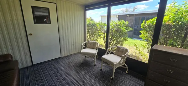 a room with wooden floor stairs and furniture